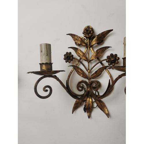 288 - Pair of gilded metal two branch wall sconces { 25cm H X 25cm W X 13cm D }.