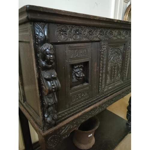 291 - 17th C. profusely carved oak court cupboard decorated with winged cherubs and lions masks supported ... 