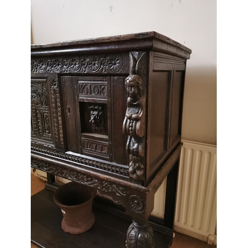 291 - 17th C. profusely carved oak court cupboard decorated with winged cherubs and lions masks supported ... 