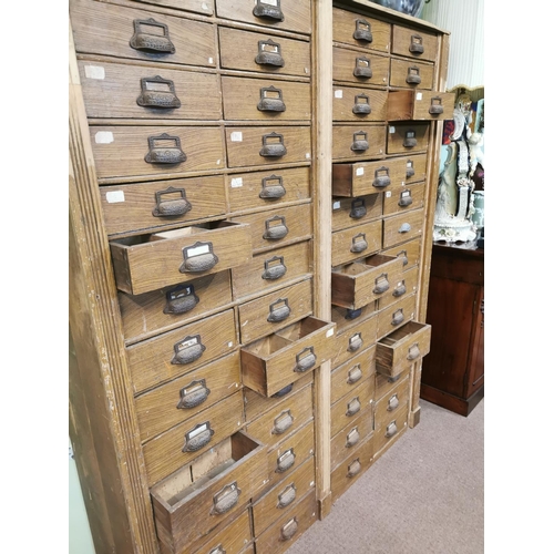 303 - Early 20th. C. scumbled pine bank of fifty six drawers { 188cm H X 163cm W X 39cm D }.