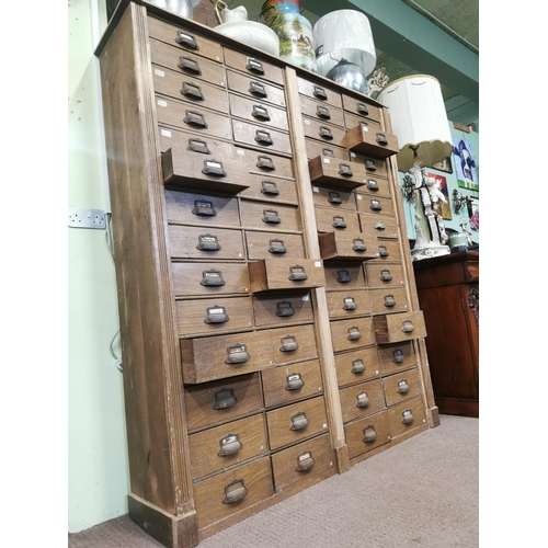 303 - Early 20th. C. scumbled pine bank of fifty six drawers { 188cm H X 163cm W X 39cm D }.