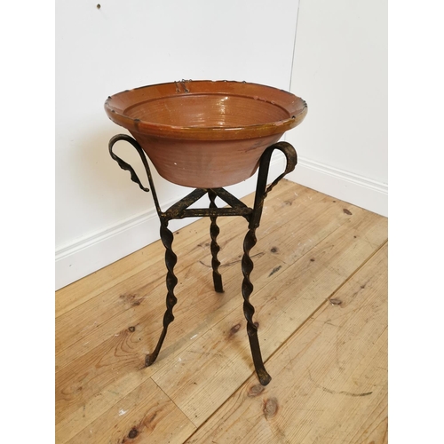 311 - Early 20th C glazed terracotta bowl on wrought iron stand. {67 cm H x 36 cm Diam}.