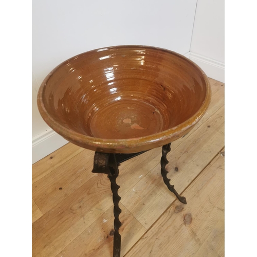 312 - Early 20th C. glazed terracotta bowl on wrought iron stand. {55 cm H x 42 cm Diam}.