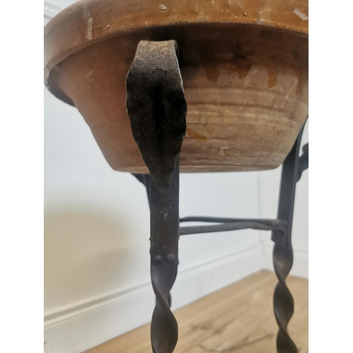 312 - Early 20th C. glazed terracotta bowl on wrought iron stand. {55 cm H x 42 cm Diam}.