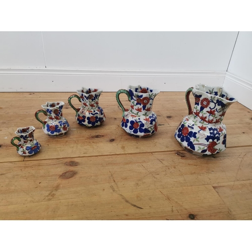 331 - Set of five graduated hand painted stoneware water jugs.  Largest {25 cm H x 20 cm W x 23 cm D} and ... 