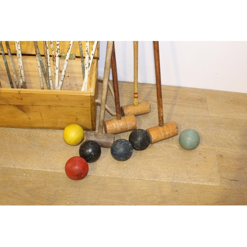 394 - Croquet set in original box { 25cm H X 107cm W X 23cm D }.