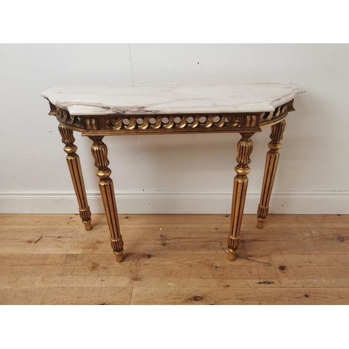 398 - Giltwood consul table the marble top above an open work frieze raised on turned tapered legs { 74cm ... 