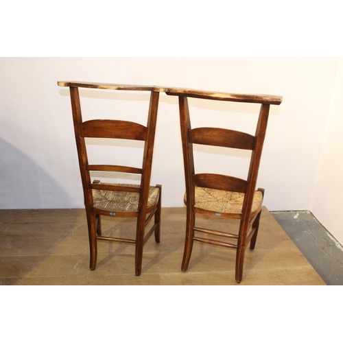 412 - Pair of early 20th. C. oak ladder backed chairs with rush seating { 98cm H X 38cm W X 34cm D }.