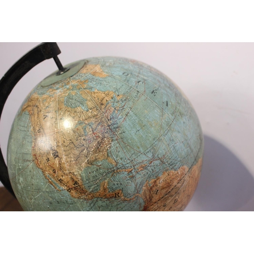 425 - World globe on cast iron stand { 64cm H X 33cm Dia }.