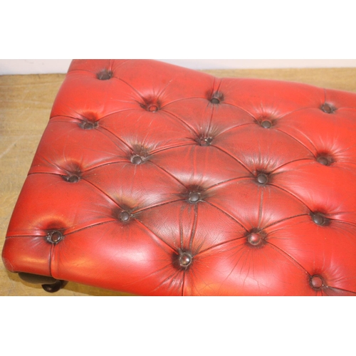 426 - Deep buttoned leather upholstered foot stool raised on Queeen Ann legs { 30cm H X 66cm W X 48cm D }.