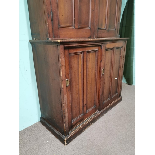 433 - 19th. C. stained pine estate cupboard with two panelled doors over two panelled doors raised on plin... 