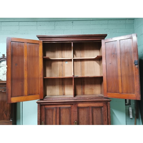 433 - 19th. C. stained pine estate cupboard with two panelled doors over two panelled doors raised on plin... 