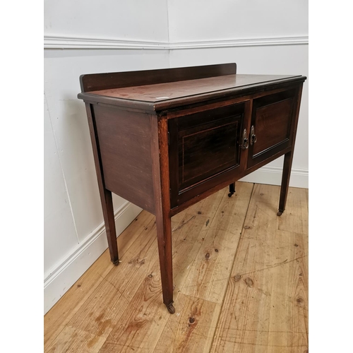 438 - Edwardian mahogany dressing table the gallery back above two panelled doors raised on square legs { ... 