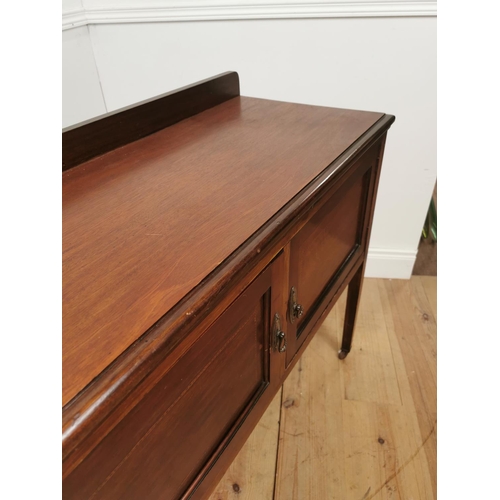 438 - Edwardian mahogany dressing table the gallery back above two panelled doors raised on square legs { ... 