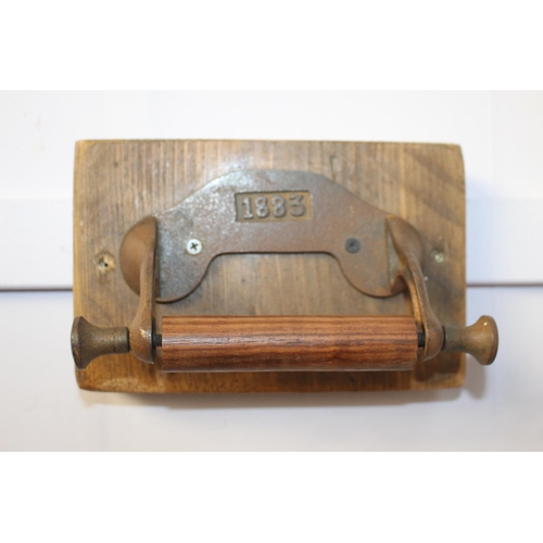 495 - Metal and wood toilet roll holder stamped 1883 { 14cm H X 20cm W X 10cm D }.