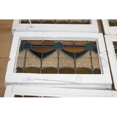 526 - Fourteen stain glass windows with cast iron frames and two unframed stain glass panes { four 40cm H ... 