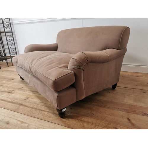 545 - Upholstered two seater sofa in the Howard style { 80cm H X 140cm W X 110cm D }.