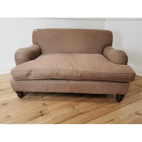 545 - Upholstered two seater sofa in the Howard style { 80cm H X 140cm W X 110cm D }.