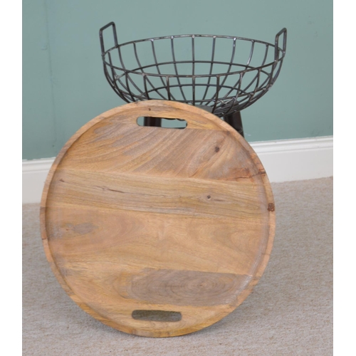 551 - Coffee table with wooden tray top above a storage basket raised on three tapered legs, in the vintag... 