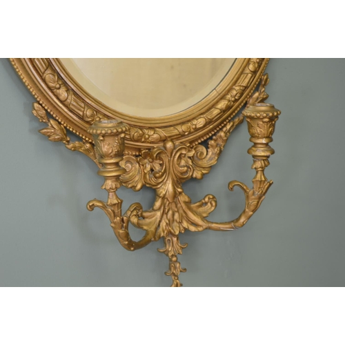 552 - 19th. C.  gilt wood oval wall mirror with sconces . { 86cm H X 44cm W }.