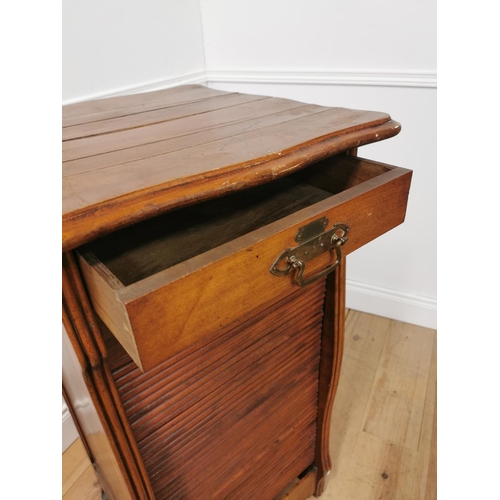 6 - Early 20th. C. oak tambour cabinet with single short drawers above the tambour door enclosing shelve... 