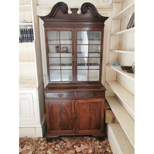 628 - Georgian mahogany bookcase, the swan necked pediment above two astragal glazed doors over two blind ... 