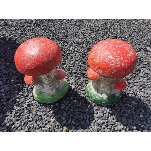 649 - Set of two painted composition toad stools {33 cm H x 22 cm Dia.}.