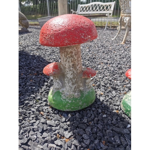 649 - Set of two painted composition toad stools {33 cm H x 22 cm Dia.}.