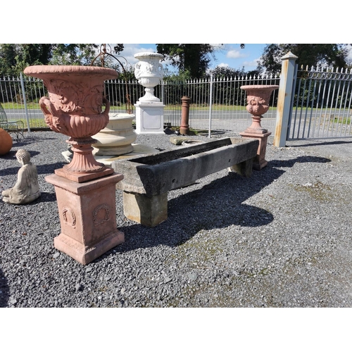 669 - Pair of good quality moulded terracotta urns decorated with swags on pedestals in the Georgian manne... 