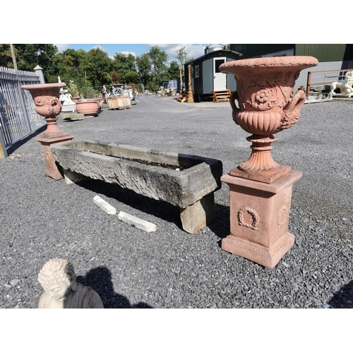 669 - Pair of good quality moulded terracotta urns decorated with swags on pedestals in the Georgian manne... 