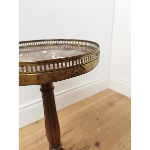 686 - Mahogany wine table the brass gallery above a marble top on turned reeded column and three outswept ... 