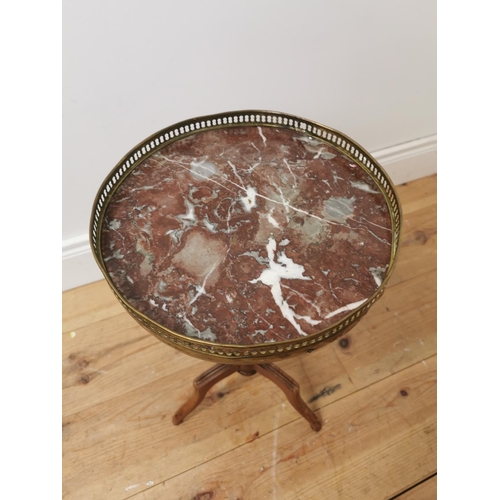 686 - Mahogany wine table the brass gallery above a marble top on turned reeded column and three outswept ... 