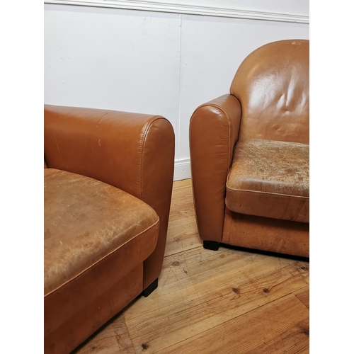 700 - Pair of leather upholstered club chairs raised on tapered feet {87 cm H x 86 cm W x 80 cm D}.