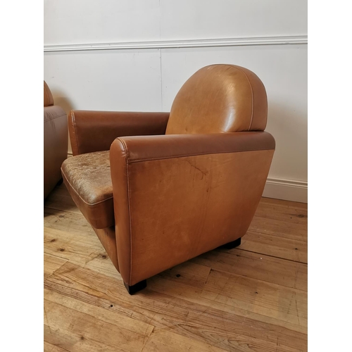 700 - Pair of leather upholstered club chairs raised on tapered feet {87 cm H x 86 cm W x 80 cm D}.