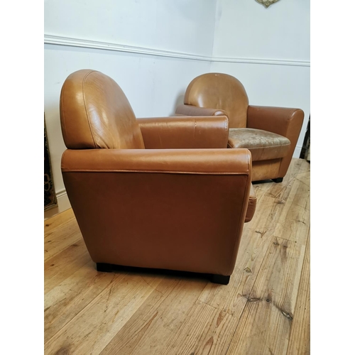 700 - Pair of leather upholstered club chairs raised on tapered feet {87 cm H x 86 cm W x 80 cm D}.