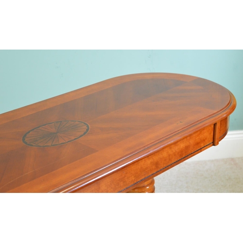 712 - Walnut oval coffee table raised on turned supports and four out swept legs in the Regency style { 65... 