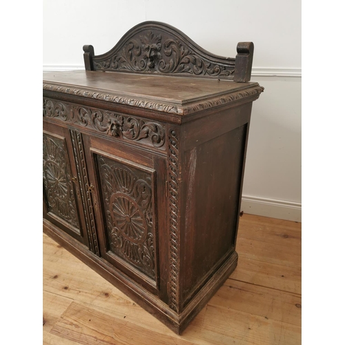 780 - 19th. C. ornately carved oak side cabinet the gallery back above a long drawer and two panelled door... 