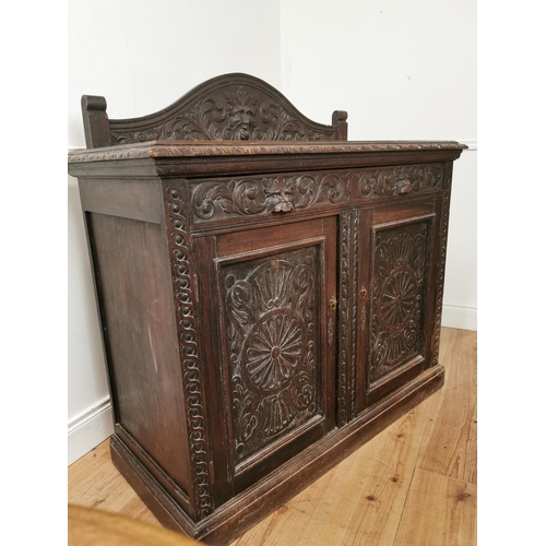 780 - 19th. C. ornately carved oak side cabinet the gallery back above a long drawer and two panelled door... 