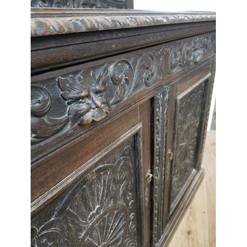 780 - 19th. C. ornately carved oak side cabinet the gallery back above a long drawer and two panelled door... 