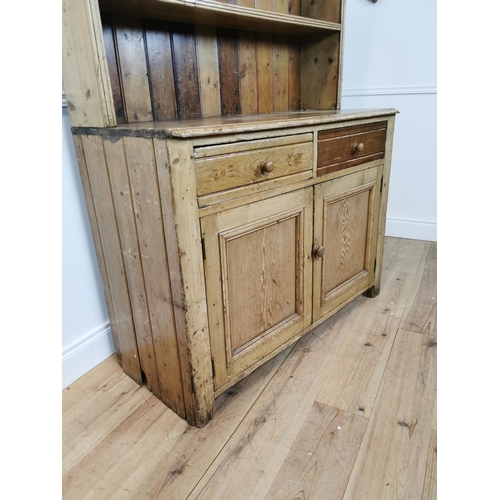 79 - 19th C. Irish pine kitchen dresser with open shelves above two drawers and two blind doors {197 cm H... 