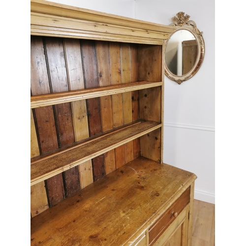 79 - 19th C. Irish pine kitchen dresser with open shelves above two drawers and two blind doors {197 cm H... 