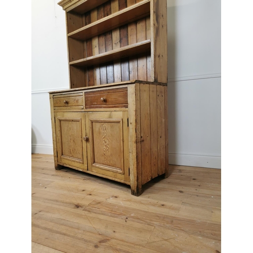 79 - 19th C. Irish pine kitchen dresser with open shelves above two drawers and two blind doors {197 cm H... 