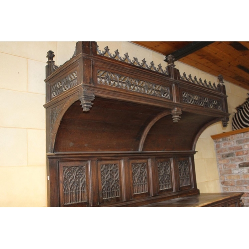 796 - 19th C. ornately carved oak side board the canopy top above two panelled doors and open shelf flanke... 