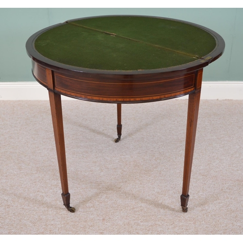 823 - Edwardian inlaid mahogany demi  - lune turn over leaf games table raised on tapered square legs. { 7... 