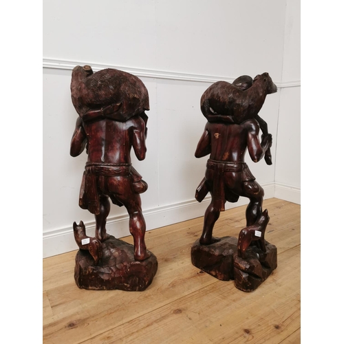 850 - Pair of carved hardwood figures of Hunters. { 10cm H X 36cm W X 30cm D }.