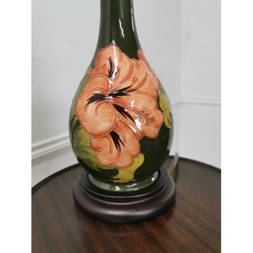 860 - Moorcroft green Hibicus pattern pottery table lamp mounted on wooden base . { 39cm H X 13cm Dia }.