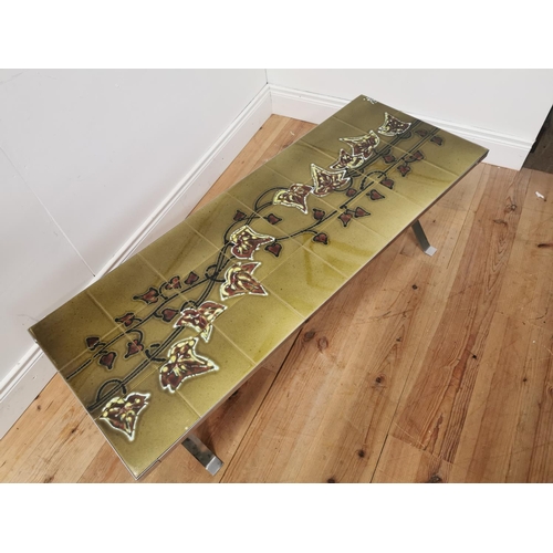 862 - Mid century chrome coffee table with decorative tiled top. { 42cm H X 142cm W X 47cm D }.