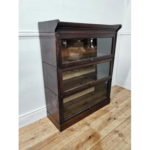 932 - 1950's oak sectional bookcase with three glazed sliding doors raised on plinth base { 110cm H X 87cm... 