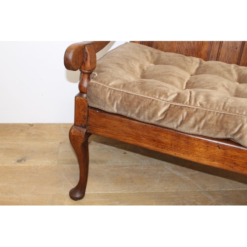 101 - 19th. C. oak settle with upholstered cushion raised on Queen Ann style legs { 106cm H X 183cm W X 68... 