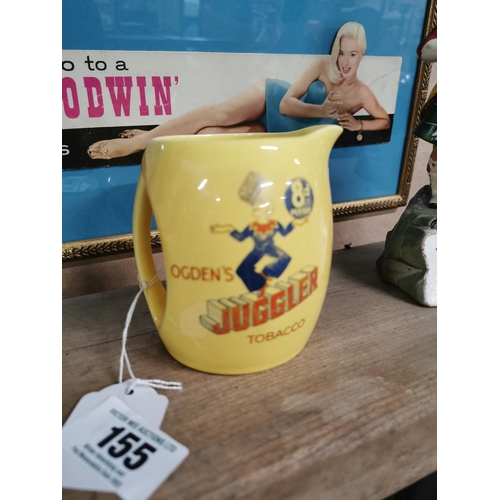 155 - Ogden's Juggler Tobacco advertising jug. 8 pence per ounce. {11 cm H x 10 cm W x 9 cm D}.